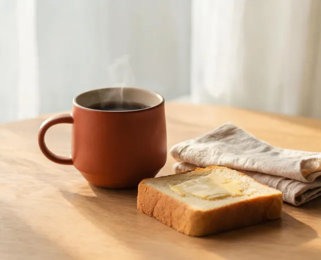 Insulated coffee mug on breakfast table